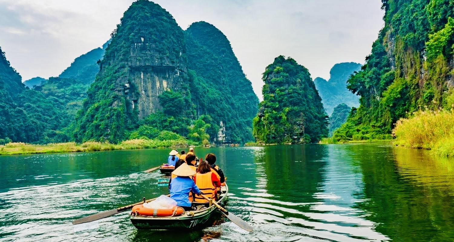Peaceful boat ride through limestone mountains in Ninh Binh, Vietnam – a quiet local experience away from tourist crowds