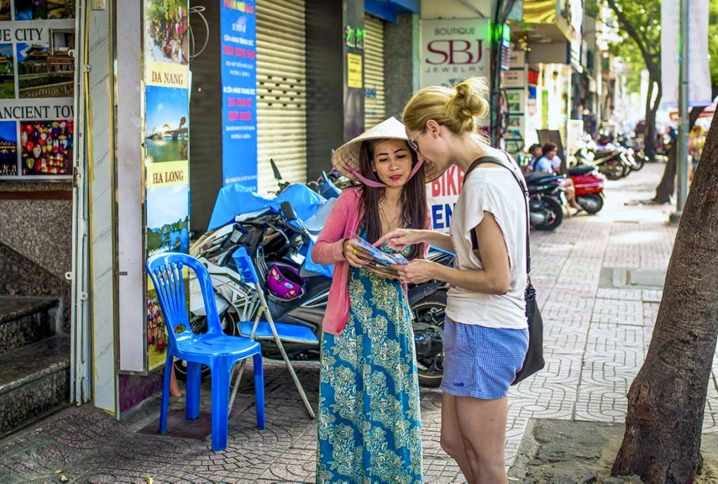Tourists spending time together at a small street cafe in Vietnam