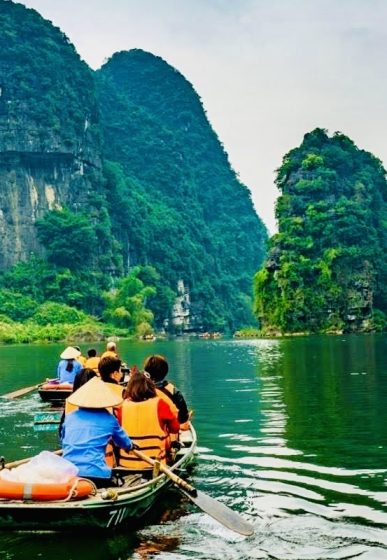 Peaceful boat ride through limestone mountains in Ninh Binh, Vietnam – a quiet local experience away from tourist crowds